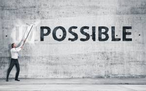 Man turning the word "Impossible" into "Possible"